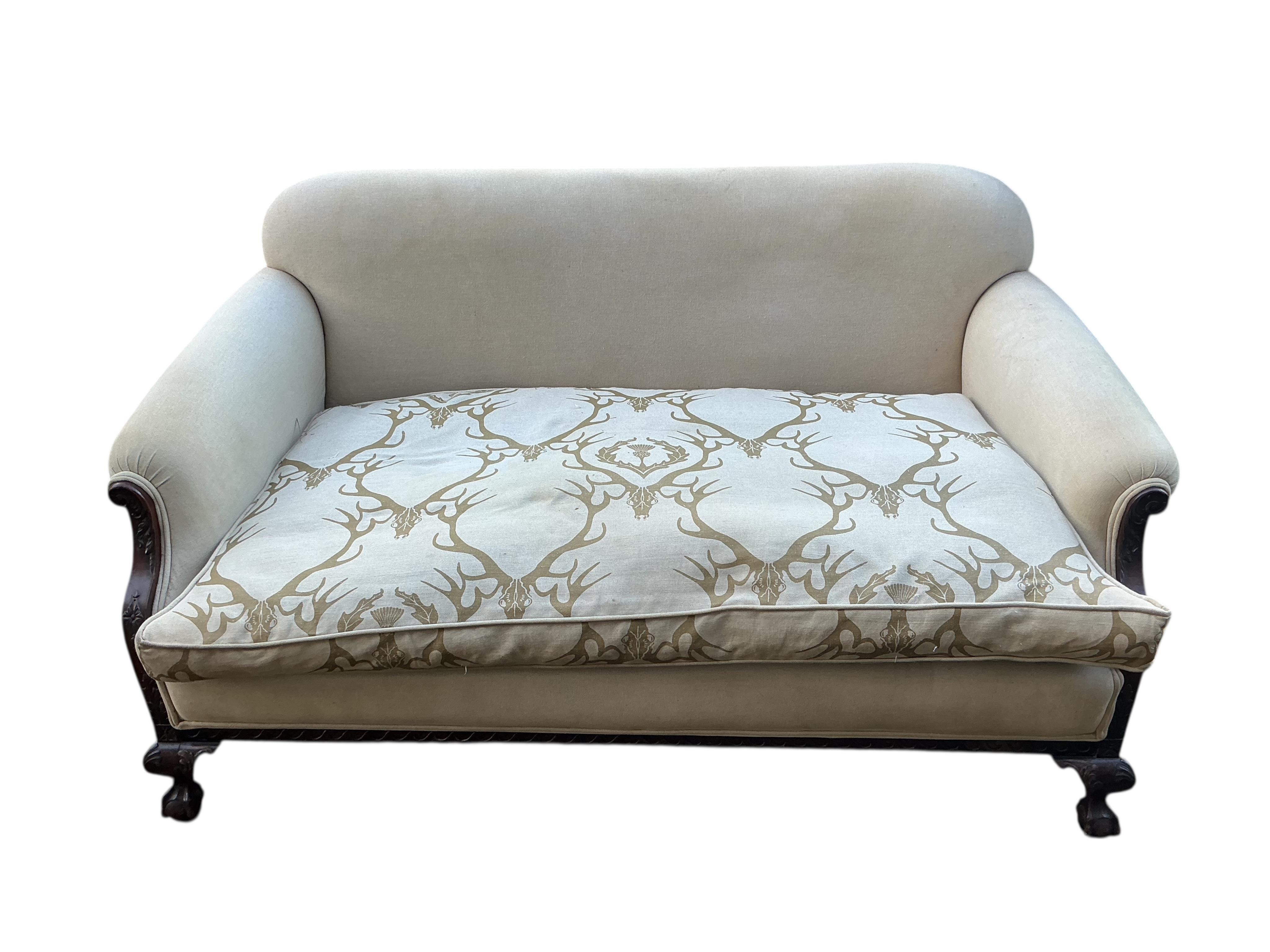 An early 20th century upholstered settee with stag head printed cushion seat, width 150cm, depth 84cm, height 76cm